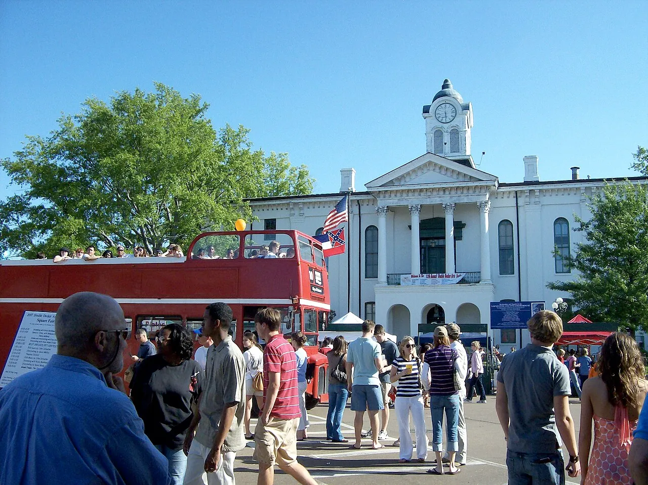 A double-decker bus passing the Lafayette County Courthouse on the square in Oxford, Mississippi